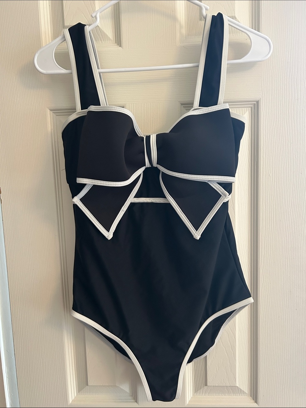 Black One-Piece Swimsuit with White Trim and Decorative Bow